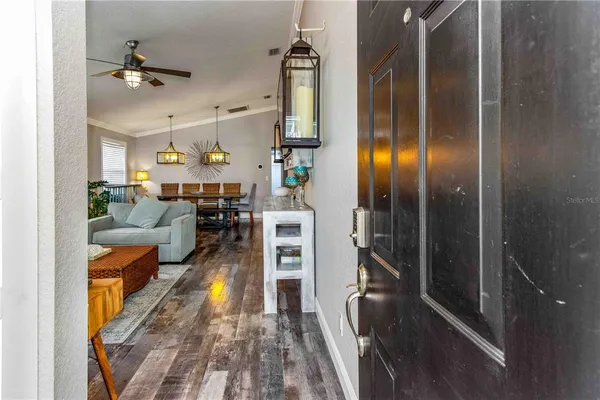 a view of a bedroom with wooden floor