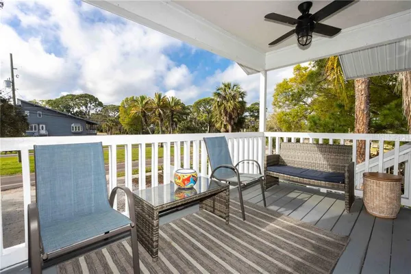 a view of a deck with table and chairs and wooden floor