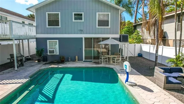 a kitchen with stainless steel appliances kitchen island granite countertop a table chairs and a refrigerator