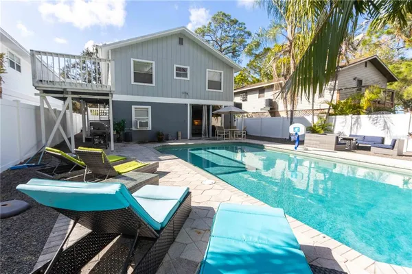 a living room with furniture and wall paintings