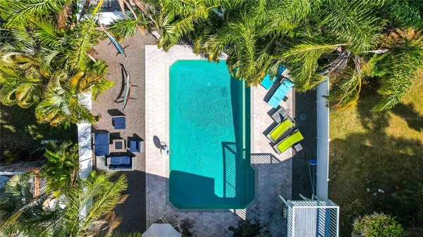a spacious bedroom with a bed and a view of kitchen