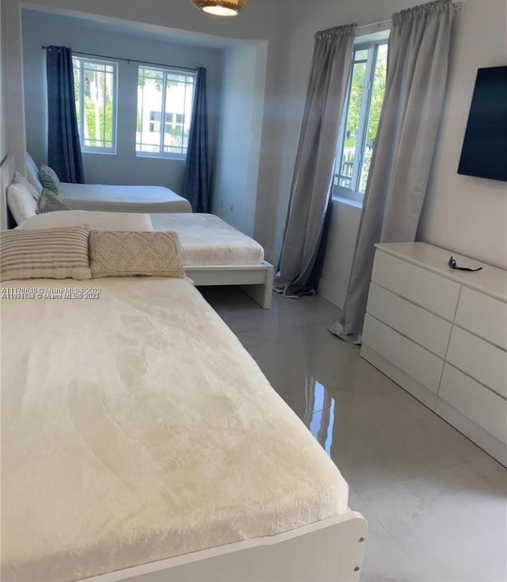 6 Northeast 50th Street Miami, FL 33137 - Photo 11 of 14 a spacious bedroom with a bed and a window