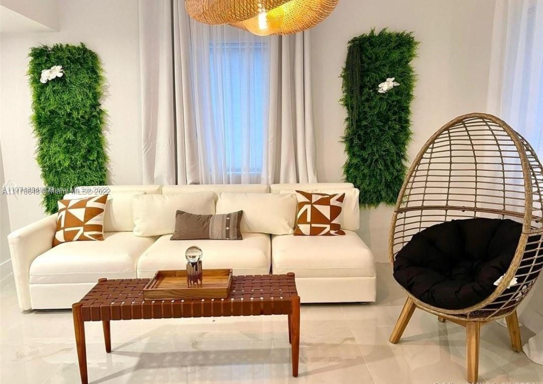6 Northeast 50th Street Miami, FL 33137 - Photo 2 of 14 a living room with furniture and a fireplace