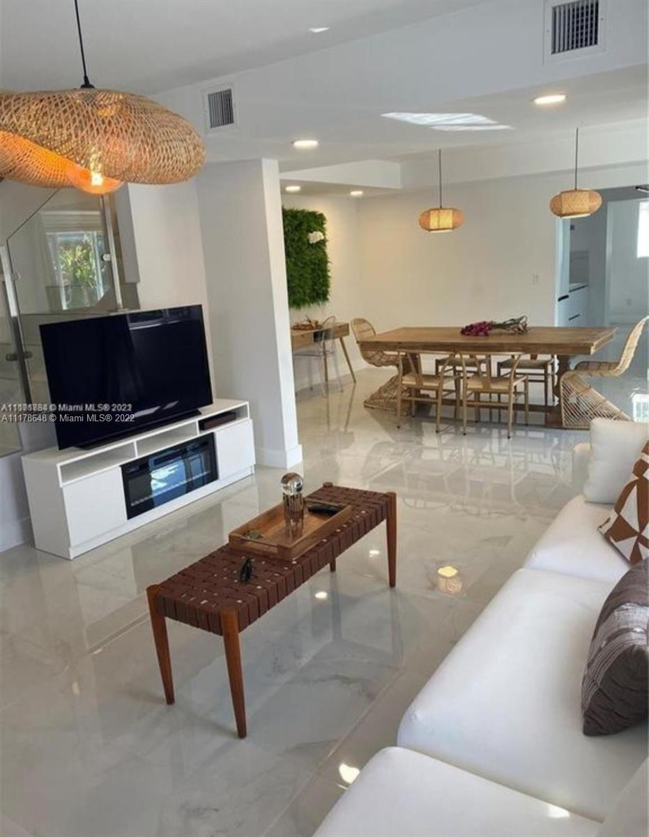 6 Northeast 50th Street Miami, FL 33137 - Photo 5 of 14 a living room with furniture and a flat screen tv