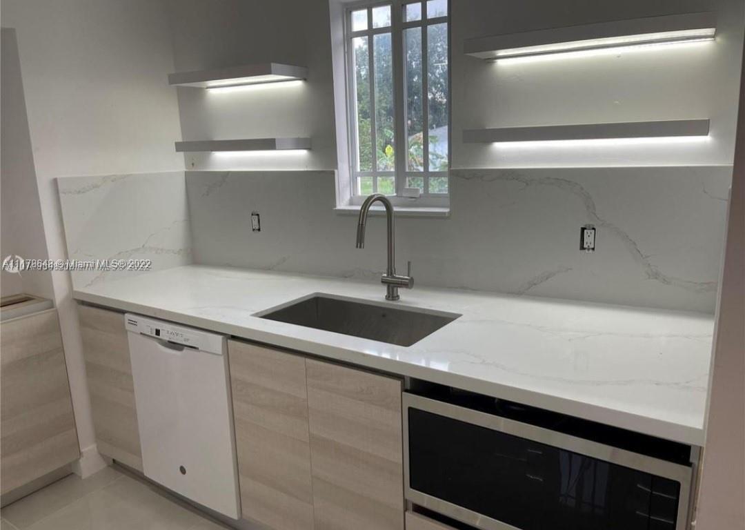 6 Northeast 50th Street Miami, FL 33137 - Photo 6 of 14 a kitchen with a sink and cabinets