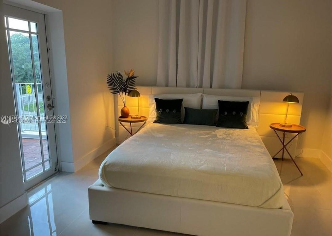 6 Northeast 50th Street Miami, FL 33137 - Photo 9 of 14 a bedroom with a bed and wooden floor