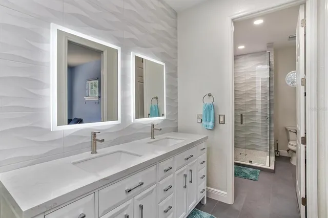 a bathroom with double vanity sink and a mirror