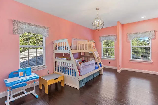 a bedroom with furniture and a large window