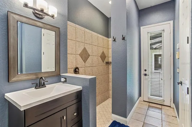 a bathroom with a sink vanity and a mirror