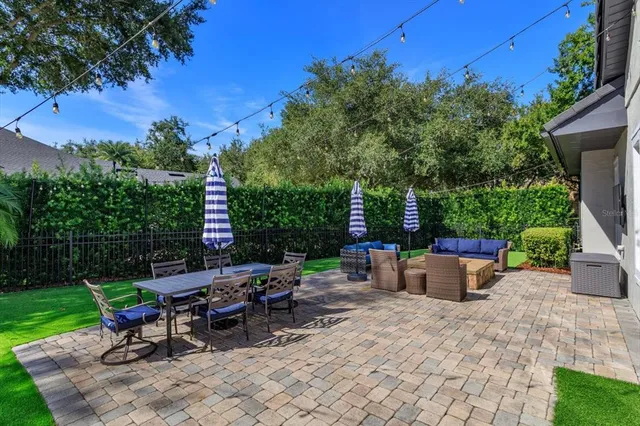 a view of a backyard with sitting area