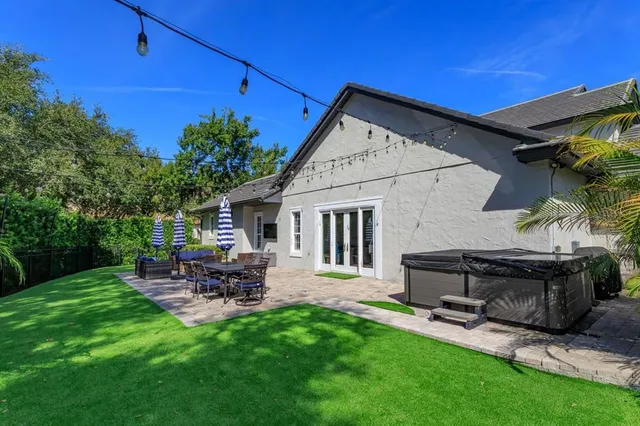 a backyard of a house with table and chairs