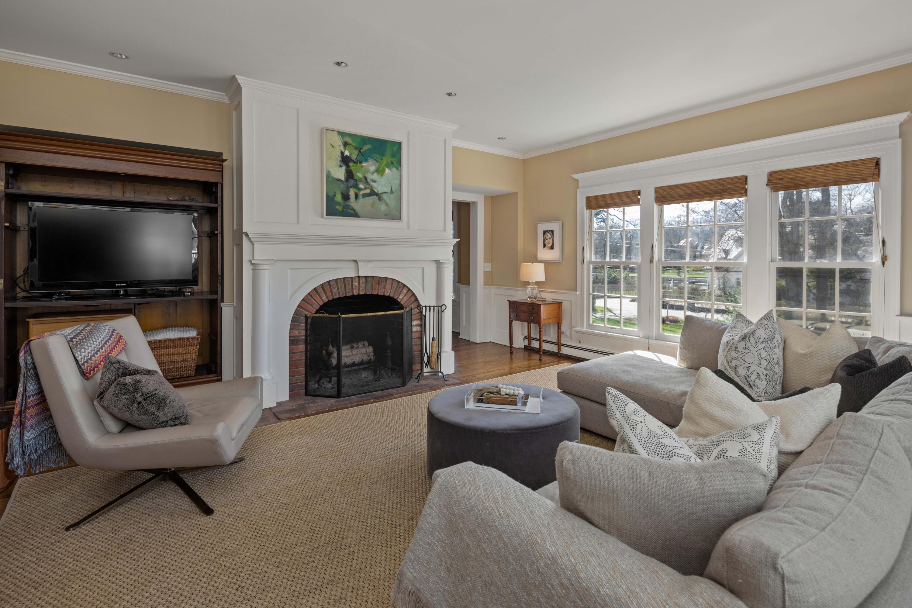 3 Edgehill Drive Darien, CT 06820 - Photo 19 of 40 a living room with furniture a fireplace and a flat screen tv
