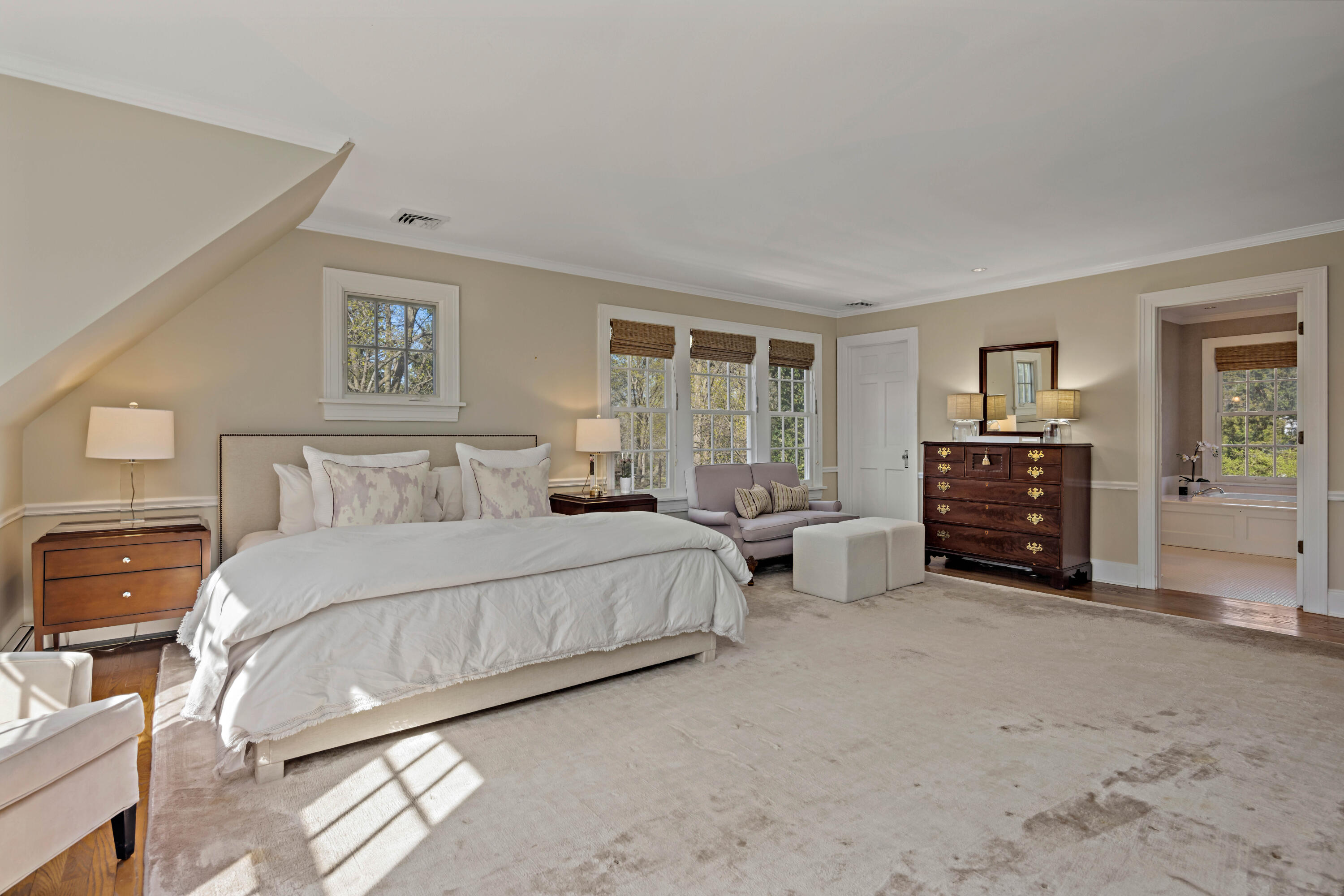 3 Edgehill Drive Darien, CT 06820 - Photo 23 of 40 a spacious bedroom with a bed a couch and a window