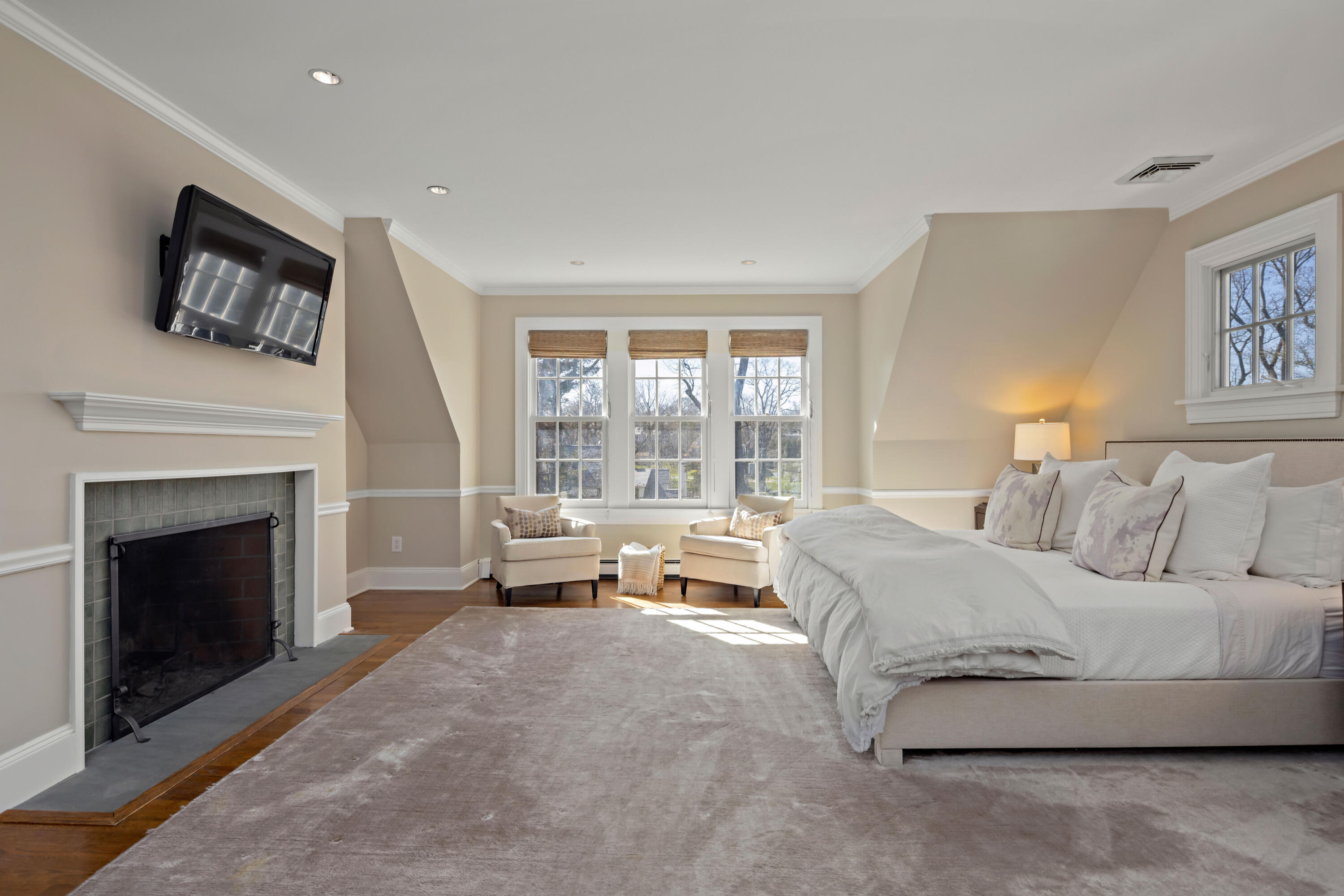 3 Edgehill Drive Darien, CT 06820 - Photo 24 of 40 a spacious bedroom with a bed and a fireplace
