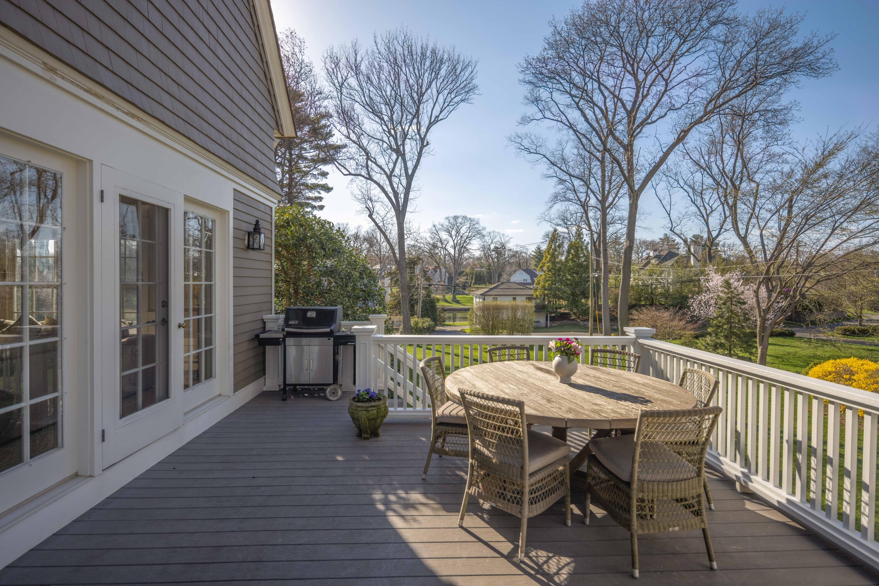 3 Edgehill Drive Darien, CT 06820 - Photo 38 of 40 a view of a patio with dining table and chairs with wooden floor and fence