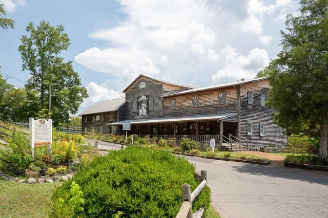 a view of a patio with table and chairs under an umbrella