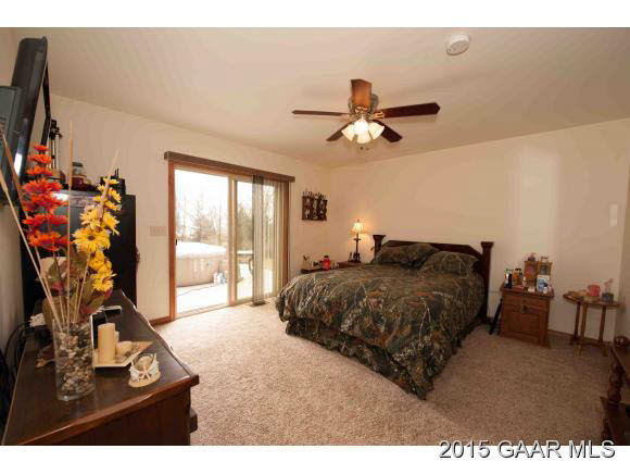 3624 Rockfish Road Grottoes, VA 24441 - Photo 11 of 26 a bedroom with a bed mirror on desk and a window