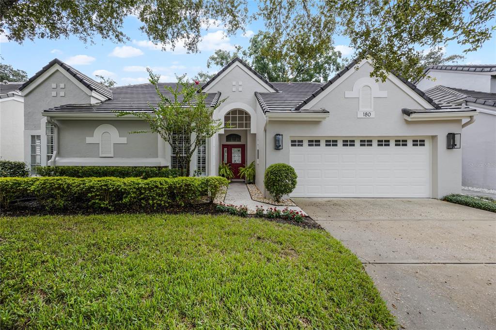 180 Wimbledon Circle Lake Mary, FL 32746 - Photo 1 of 1 a front view of a house with garden