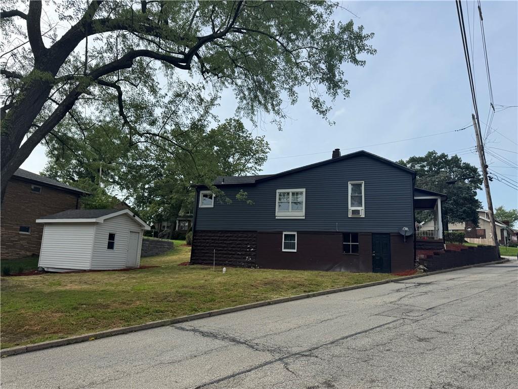 815 Braddock Road Pittsburgh, PA 15221 - Photo 6 of 31 a front view of a house with a yard and garage
