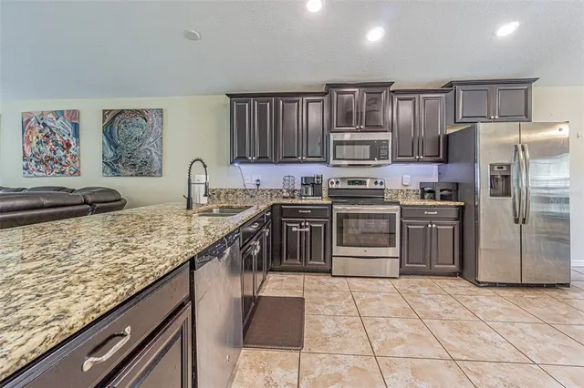 a living room with furniture and kitchen view