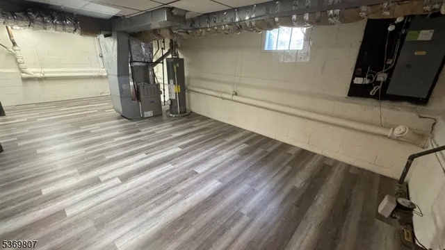 a view of a closet area with wooden floor