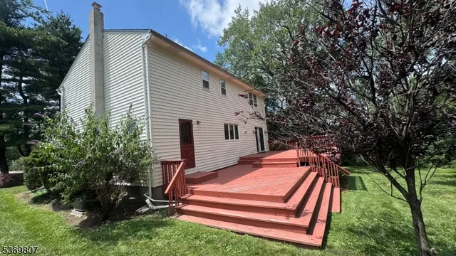 a backyard of a house with barbeque oven and trees