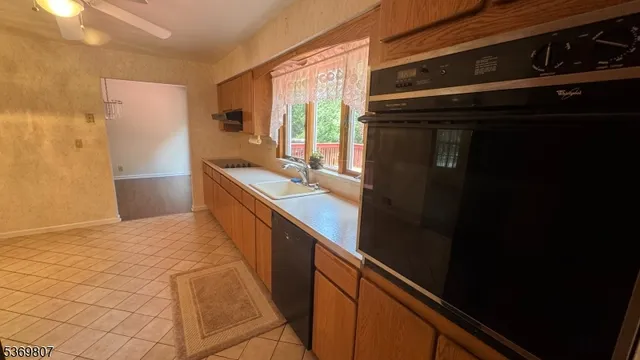 a kitchen with stainless steel appliances a sink stove and refrigerator