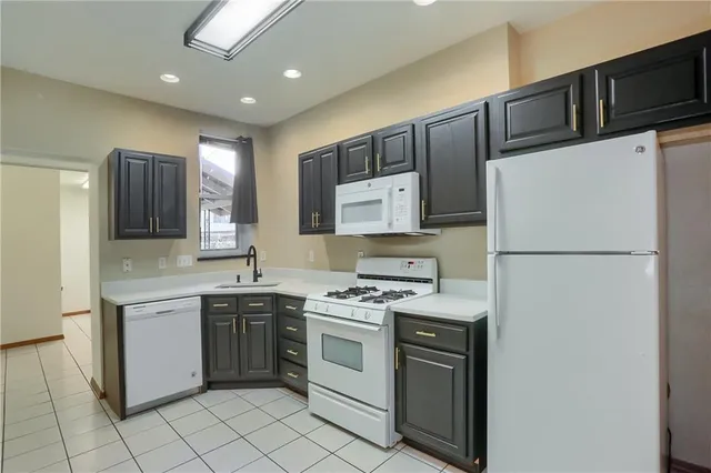 a kitchen with a stove sink and refrigerator