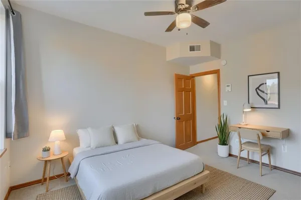 a bedroom with a bed and a lamp on table