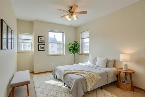 a bedroom with a bed and a chandelier