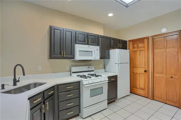 a kitchen with stainless steel appliances a stove a sink and a refrigerator