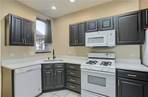 a kitchen with stainless steel appliances granite countertop a sink stove and microwave