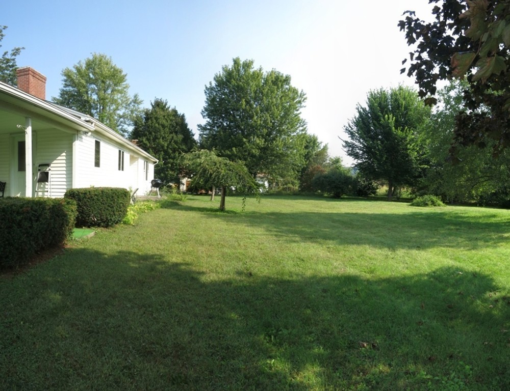 266 Hadley Road Sunderland, MA 01375 - Photo 19 of 23 a view of a house with a big yard and potted plants