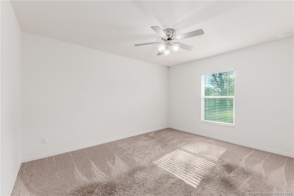 2108 Southwest Vista Road Port St. Lucie, FL 34953 - Photo 11 of 19 a view of a big room with windows and chandelier fan