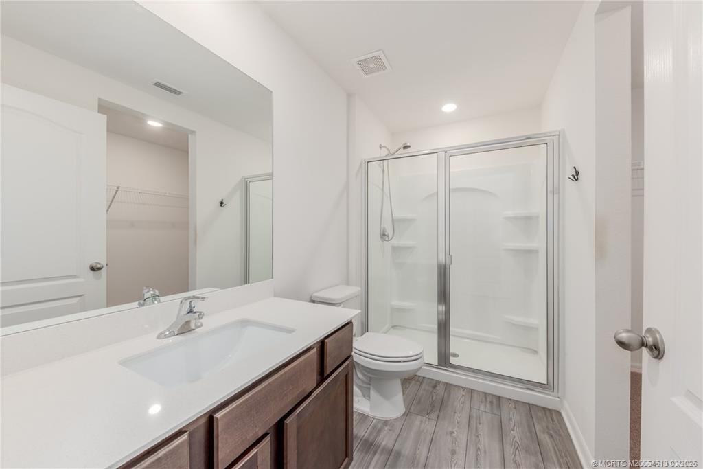 2108 Southwest Vista Road Port St. Lucie, FL 34953 - Photo 12 of 19 a bathroom with a shower sink vanity mirror and toilet