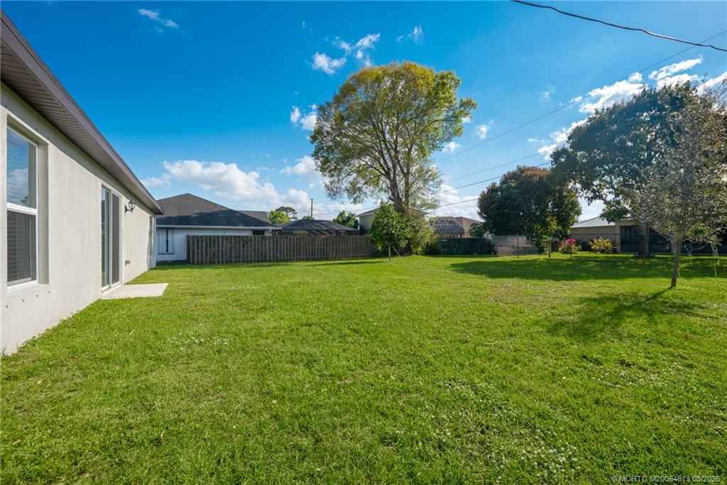 2108 Southwest Vista Road Port St. Lucie, FL 34953 - Photo 18 of 19 a front view of a house with garden