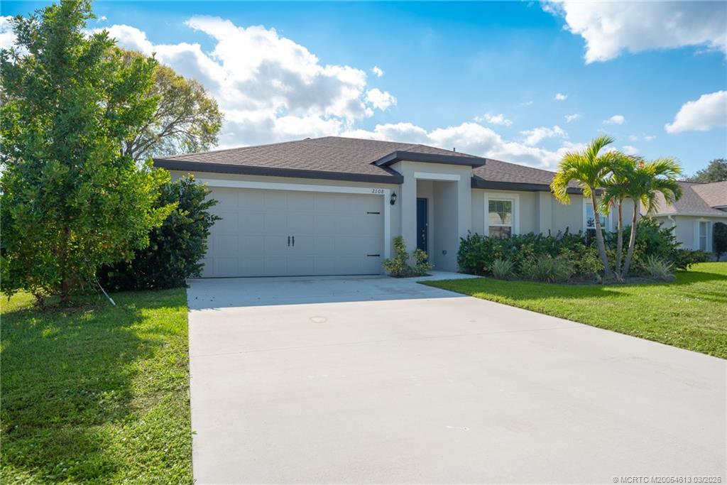 2108 Southwest Vista Road Port St. Lucie, FL 34953 - Photo 2 of 19 a view of a house with a yard and potted plants