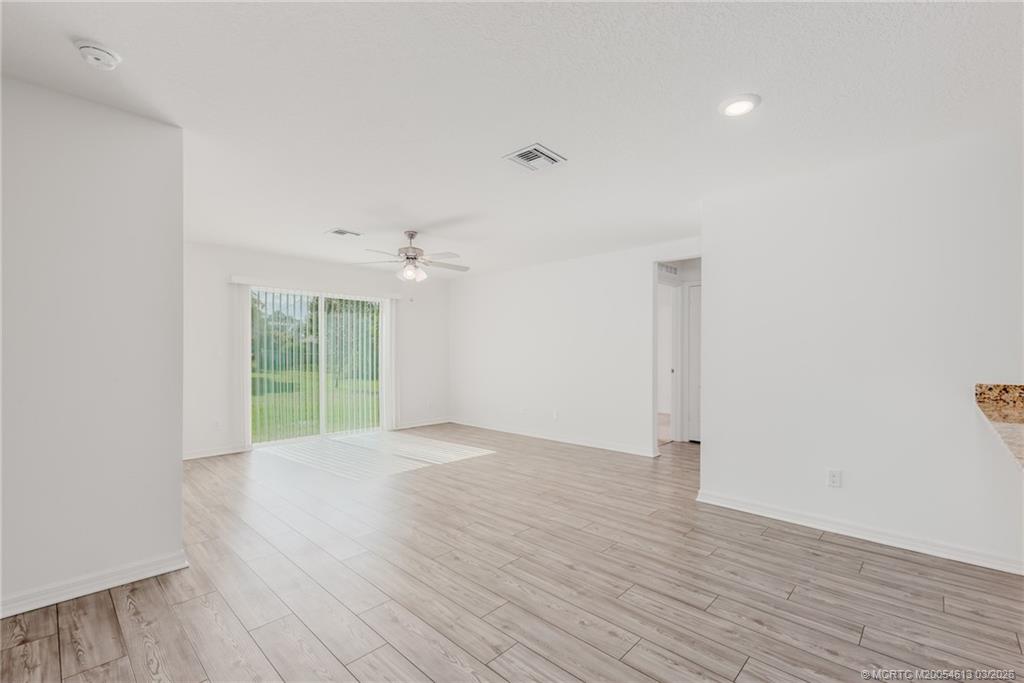 2108 Southwest Vista Road Port St. Lucie, FL 34953 - Photo 4 of 19 wooden floor in an empty room with a window