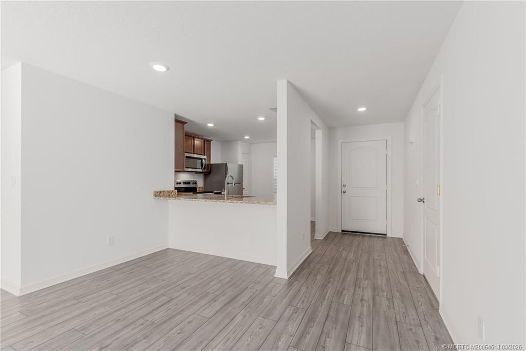 2108 Southwest Vista Road Port St. Lucie, FL 34953 - Photo 6 of 19 a view of a big room with wooden floor and a window