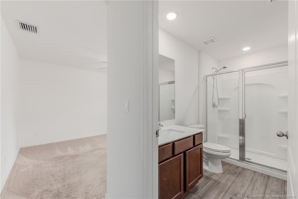 2108 Southwest Vista Road Port St. Lucie, FL 34953 - Photo 10 of 19 a bathroom with a sink a toilet and shower