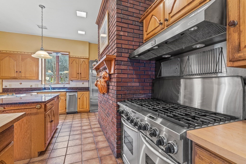 3 Myopia Road Winchester, MA 01890 - Photo 13 of 39 a kitchen with stainless steel appliances granite countertop a stove a sink dishwasher and cabinets