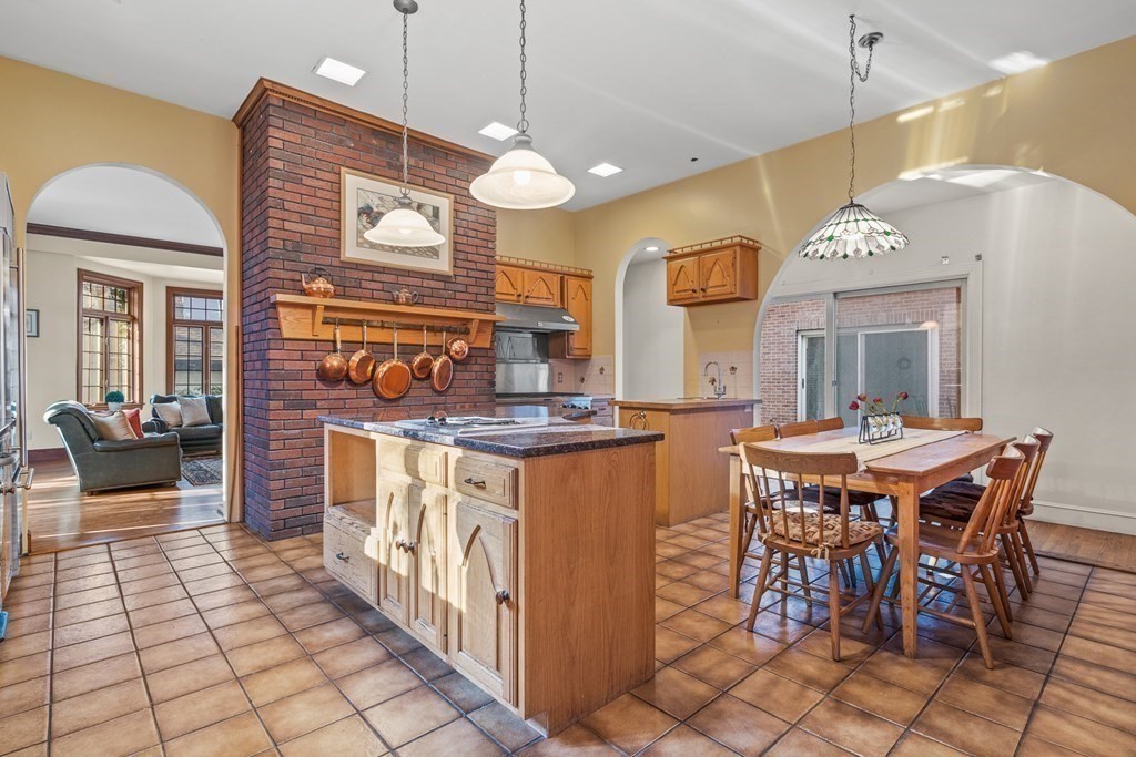 3 Myopia Road Winchester, MA 01890 - Photo 15 of 39 a kitchen with stainless steel appliances granite countertop a stove a sink a dining table and chairs
