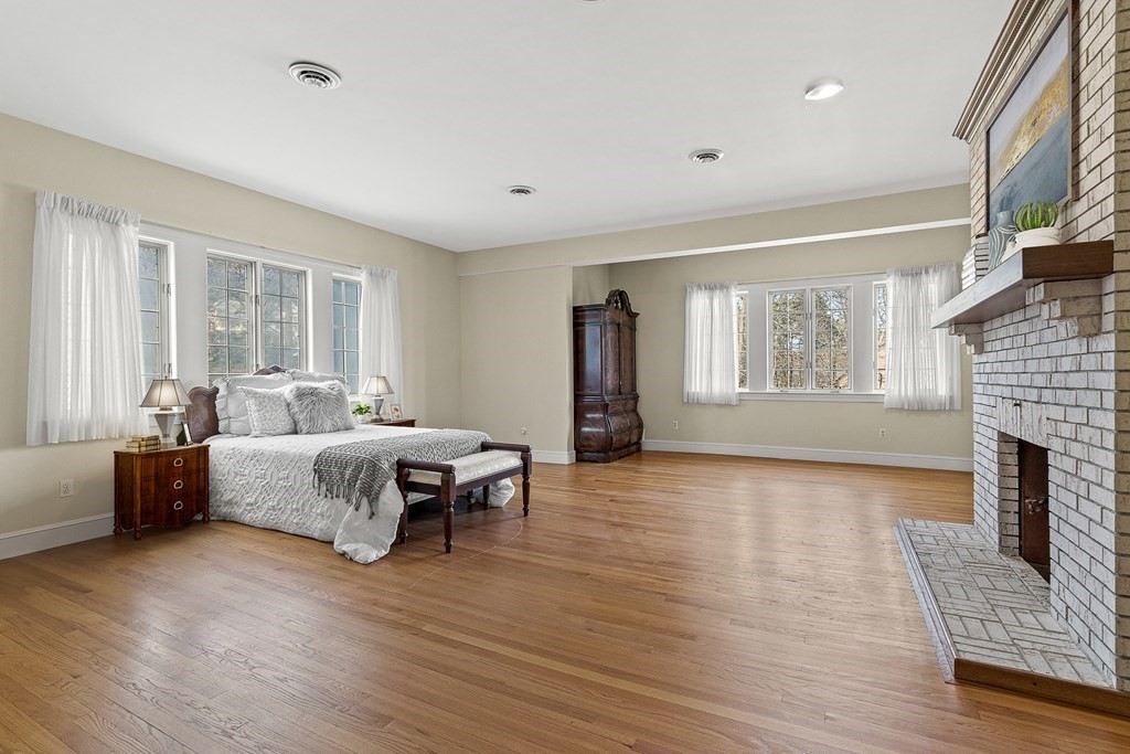 3 Myopia Road Winchester, MA 01890 - Photo 22 of 39 a spacious bedroom with a bed and a fireplace