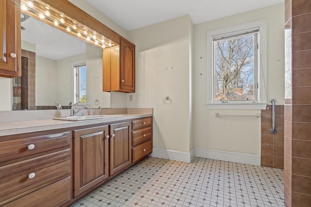 3 Myopia Road Winchester, MA 01890 - Photo 23 of 39 a bathroom with a sink a vanity and a mirror