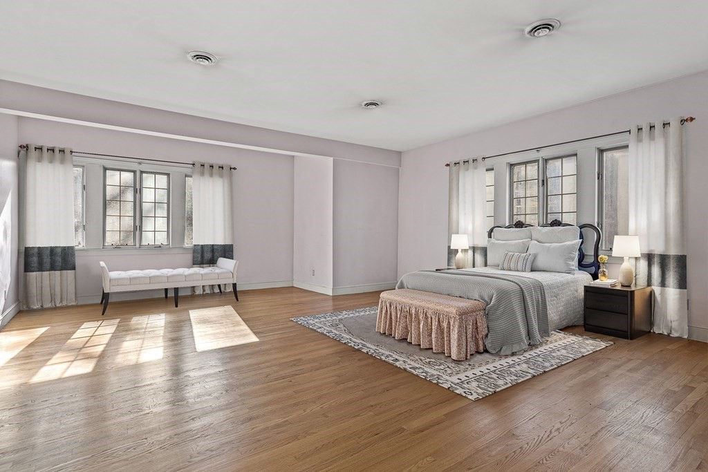 3 Myopia Road Winchester, MA 01890 - Photo 24 of 39 a spacious bedroom with a bed and wooden floor