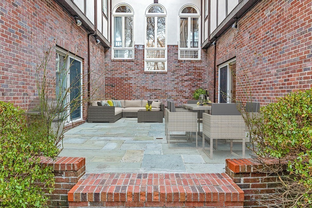 3 Myopia Road Winchester, MA 01890 - Photo 33 of 39 a view of a patio with couches table and chairs and potted plants