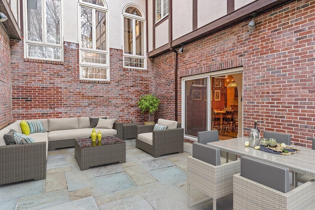 3 Myopia Road Winchester, MA 01890 - Photo 34 of 39 a view of a patio with couches table and chairs and potted plants