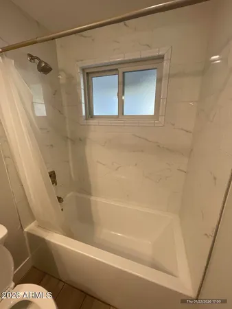 a bathroom with a toilet and a bathtub
