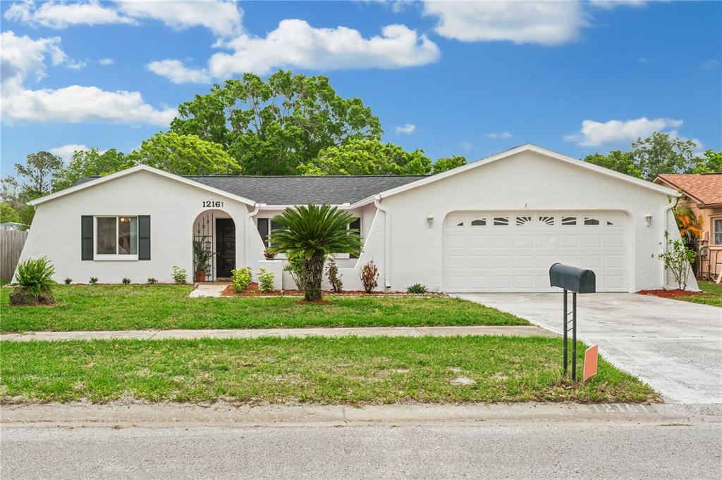 12161 Shadow Ridge Boulevard Hudson, FL 34669 - Photo 1 of 1 a front view of a house with a yard