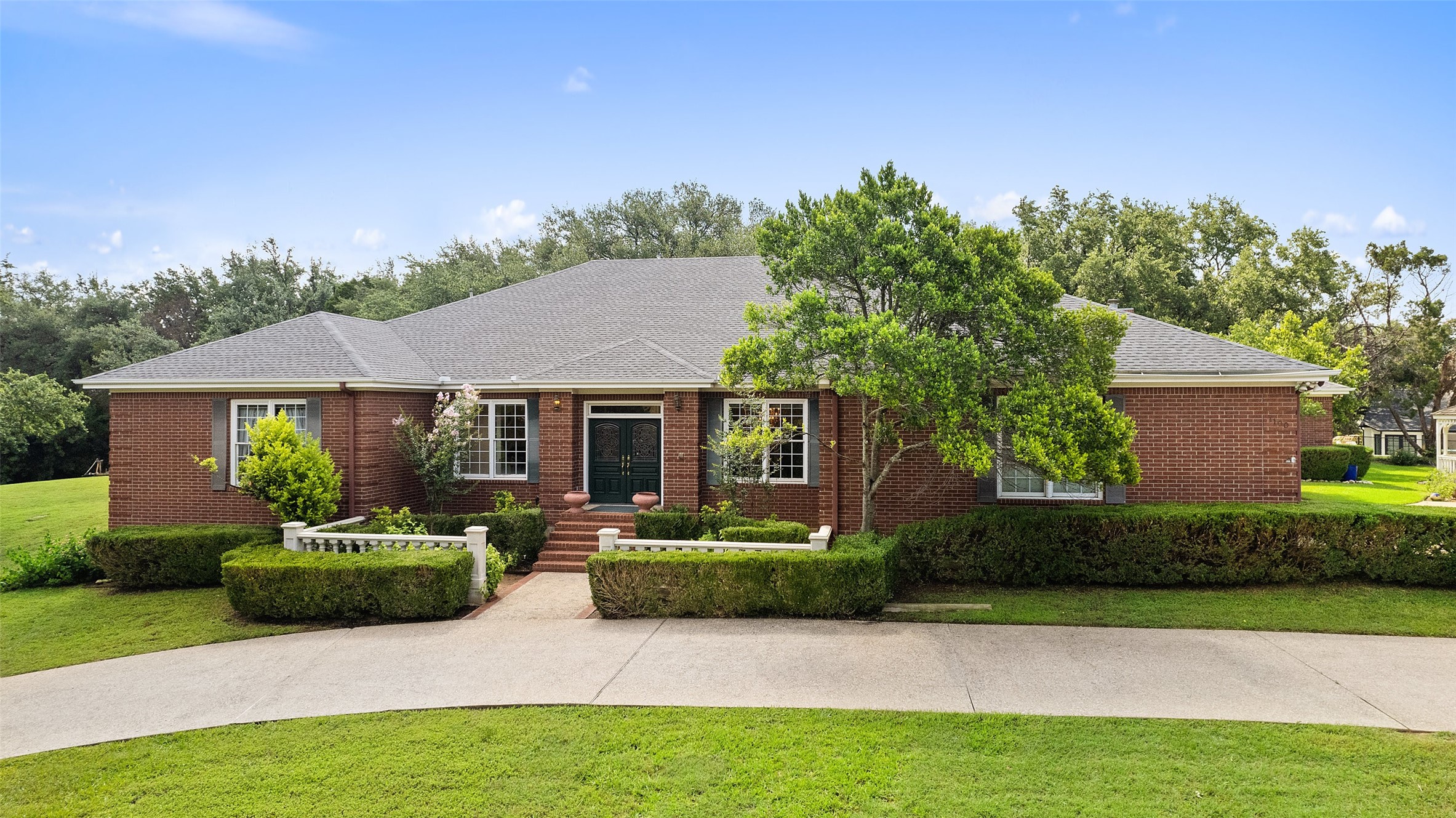 a front view of a house with a garden